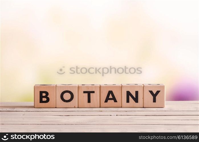 Botany sign made with cubes on a wooden garden table