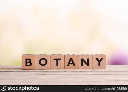 Botany sign made with cubes on a wooden garden table