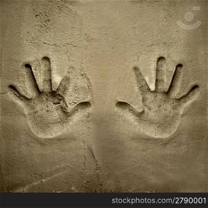 both hands print on cement mortar wall with shadow relief