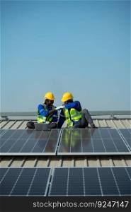 Both of Engineer in charge of solar panel installation The installation of solar energy conversion into electricity for a warehouse is currently being investigated.