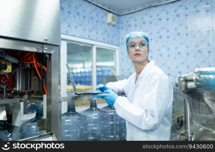 Both of female quality control workers in a drinking water factory Inspecting the quality of water tanks before importing the drinking water belt into the tank