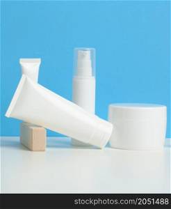 bottle and empty white plastic tubes for cosmetics on a white background. Packaging for cream, gel, serum, advertising and product promotion, mock up