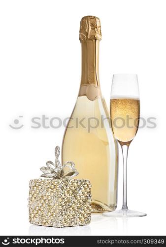Bottle and glass of champagne with christmas decoration and gift on white background