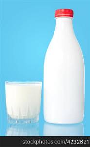 Bottle and glass of fresh milk on blue background