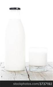 Bottle and glass of milk on white background