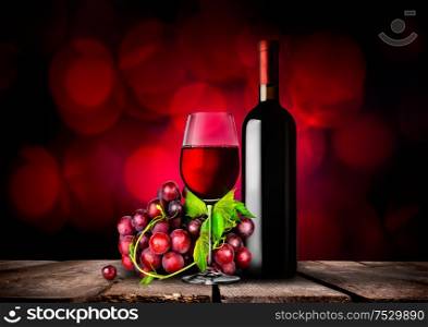 Bottle and glass of red wine and grapes. Red wine and grapes