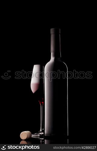 Bottle and glass of red wine with cork on black background