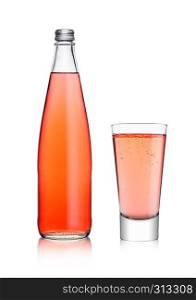 Bottle and glass of sparkling pink soda drink lemonade on white background