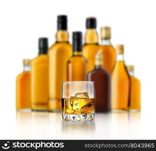 Bottle and glass of whiskey isolated on a white background