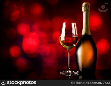 Bottle and glass of white wine on a red background