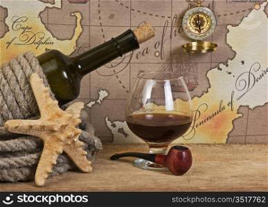 bottle and glass of wine on background of old maps
