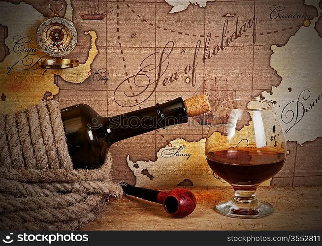 bottle and glass of wine on background of old maps