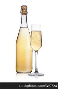 Bottle and glass of yellow champagne with bubbles on white background with reflection
