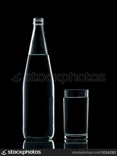 Bottle and Glass water clear isolate on over black background