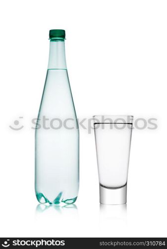 Bottle and glass with healthy sparkling water lemonade with bubbles on white