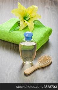 bottle hairbrush towel and flower