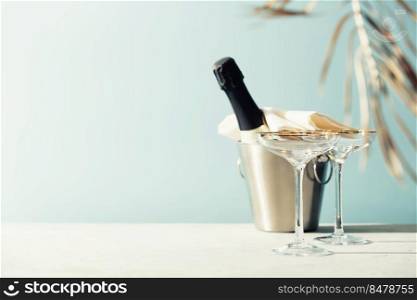 Bottle of ch&agne and glasses on sea and sky background. Summer holiday and romantic party concept