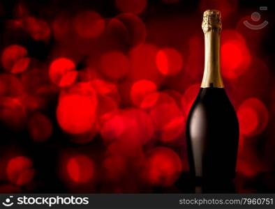 Bottle of champagne on a red background