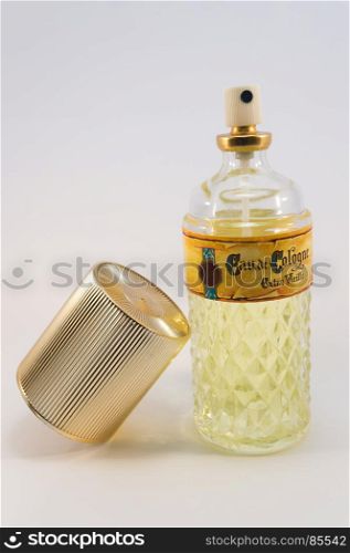 Bottle of cologne water old vintage with . Bottle of cologne water old vintage with its golden cap on a white background