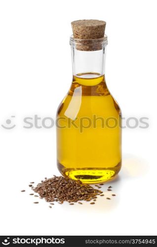 Bottle of flax seed oil ans seeds on white background