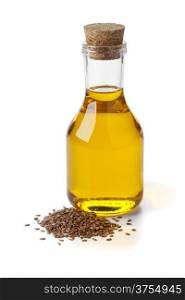 Bottle of flax seed oil ans seeds on white background