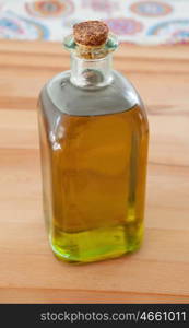 Bottle of golden olive oil on wood