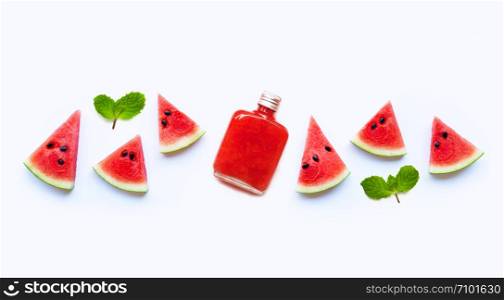 Bottle of healthy watermelon juice with slice and mint leaves isolated on a white background.