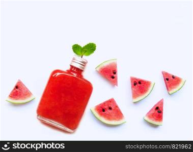 Bottle of healthy watermelon juice with slice and mint leaves isolated on white background.