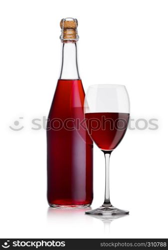 Bottle of homemade red wine and glass on white background with reflection