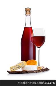 Bottle of homemade red wine with cheese selection and glass on white background