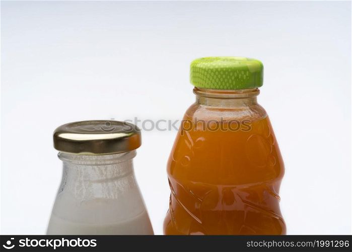 Bottle of juice and yogurt on white background. The concept of healthy eating.. Bottle of juice and yogurt on white background.