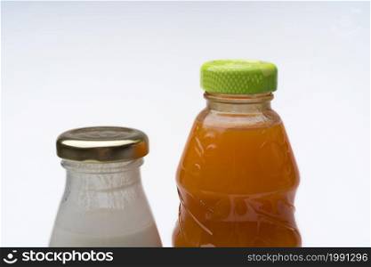 Bottle of juice and yogurt on white background. The concept of healthy eating.. Bottle of juice and yogurt on white background.