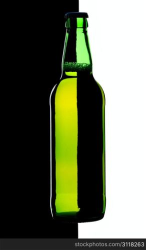 Bottle of lager beer from green glass, isolated on a black and white background.