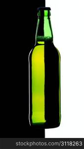 Bottle of lager beer from green glass, isolated on a black and white background.