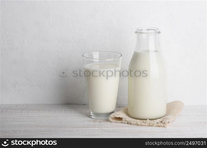 Bottle of milk and full glass on sack cloth napkin