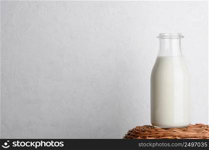 Bottle of milk on wicker basket with white background as copy space