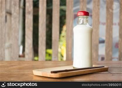 Bottle of milk on wooden table, stock photo