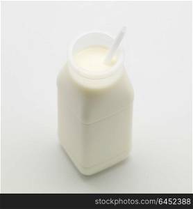 bottle of milk with white drinking straw