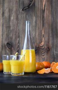Bottle of orange juice with fresh fruits