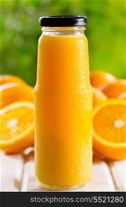 bottle of orange juice with fresh fruits