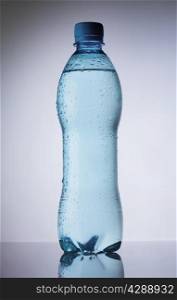 Bottle of pure water drops on gradient background