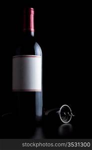 bottle of red wine and corkscrew isolated on black