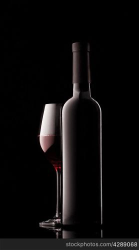 Bottle of red wine and filled the sides on a black background