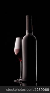 Bottle of red wine and filled the sides on a black background