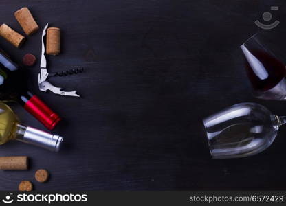 Bottle of red wine and two wine glasses on table with copy space. Glass of red wine