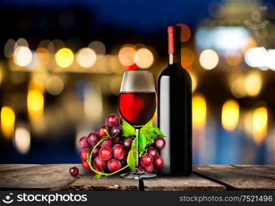 Bottle of red wine, grapes and wooden barrel