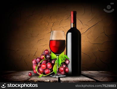 Bottle of red wine, grapes and wooden barrel. Bottle of red wine,