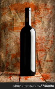 Bottle of red wine on a background of the canvas