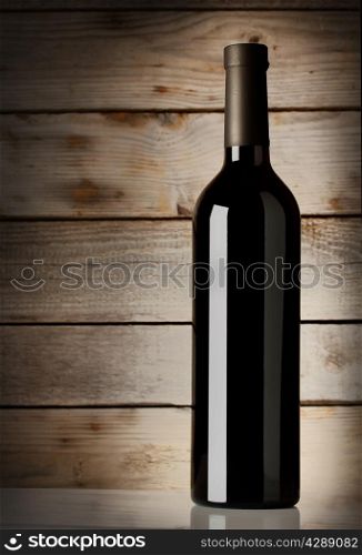 Bottle of red wine on a wooden background
