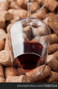 Bottle of red wine on top of various wine corks. Macro